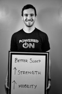 A man holding up a sign that says " better sleep ".
