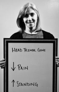 A woman with a sign in front of her head.