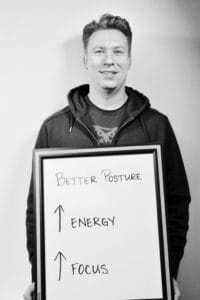 A man holding up an energy sign with arrows pointing in different directions.
