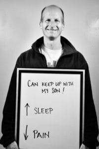 A man holding up a sign that says sleep.