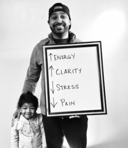 A man holding a sign with arrows pointing to the center of it.