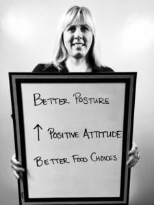A person holding up a board with words written on it.