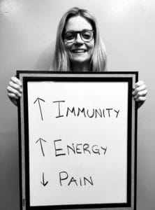 A woman holding up an energy sign and the words immunity, energy, and imunity.