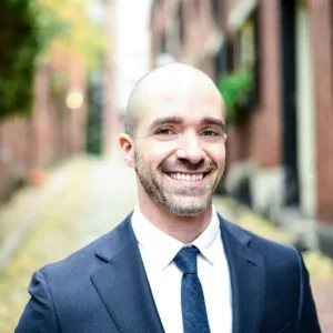 Dr Robert Mirandola in a suit and tie smiling for the camera - gonstead chiropractor for The Foundation Chiropractic