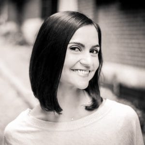 A woman with long hair smiles for the camera.