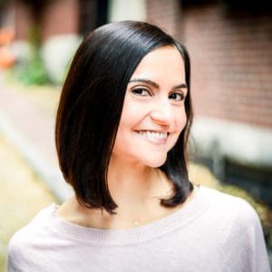A woman with black hair smiles for the camera.