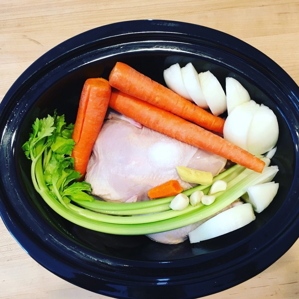 A bowl of vegetables and meat in it.
