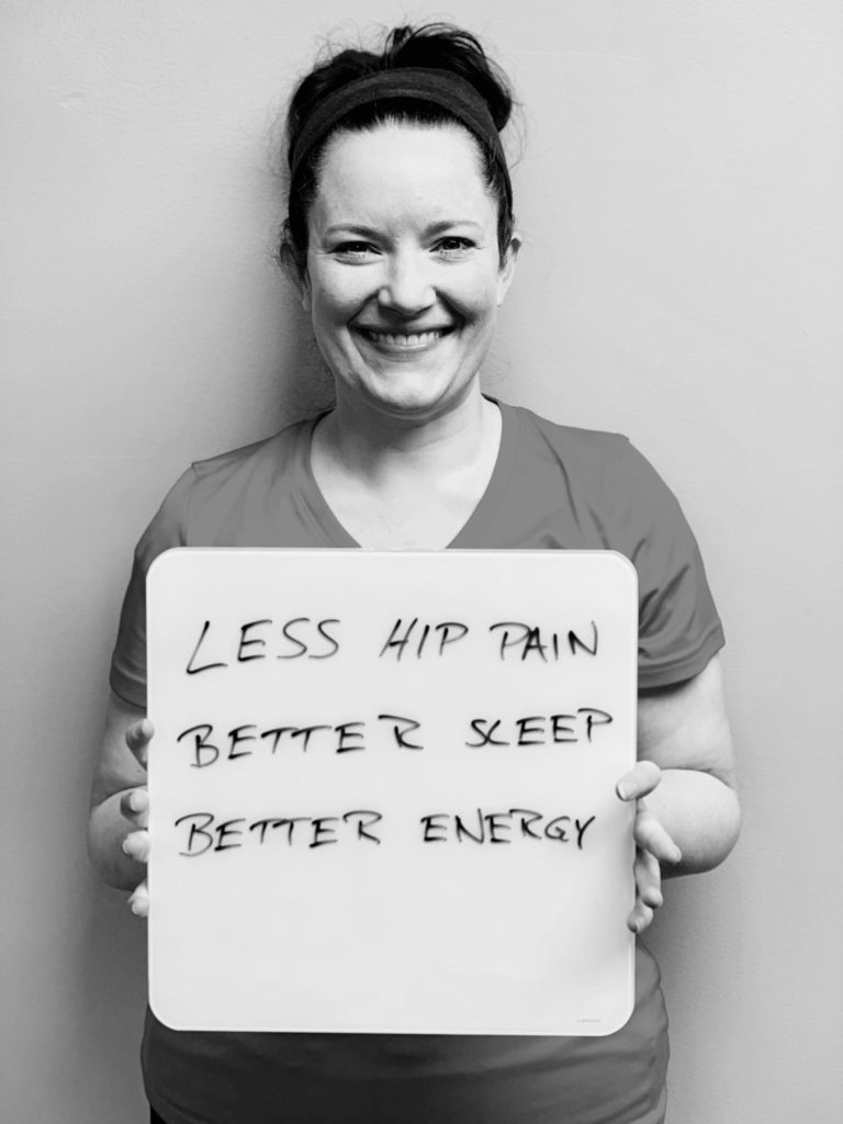 patient story- A woman holding up a sign that says less hip pain, better sleep and better energy.