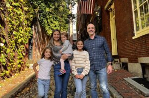 A family posing for a picture in the street.