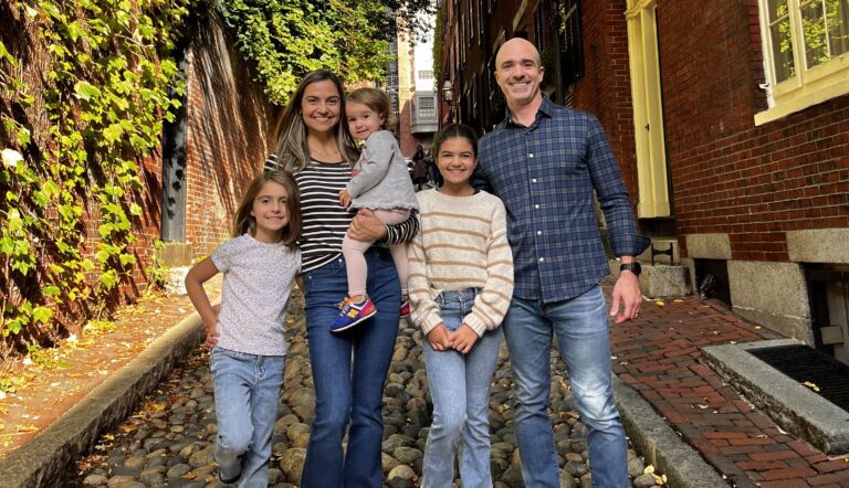 A family posing for a picture in the fall.