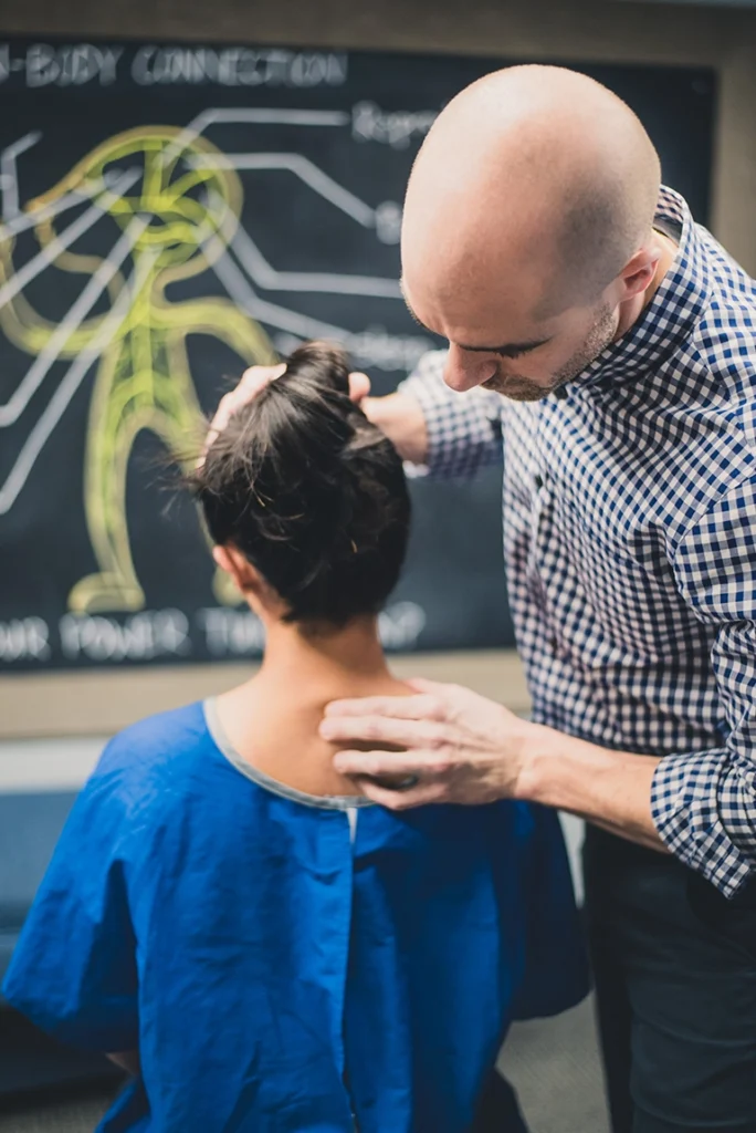 Dr Mirandola adjusting a patient with neck pain - gonstead chiropractor in Massachusets