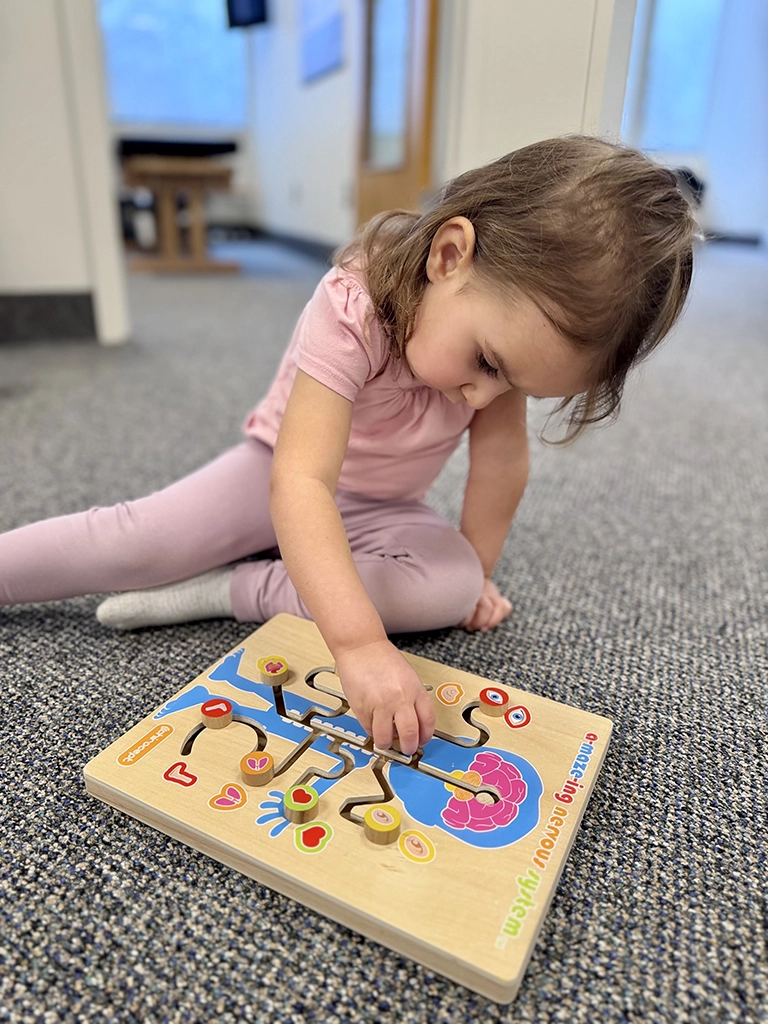 child playing with a toy on at The Foundation Chiropractic office