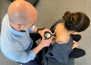Gonstead method - instrumentation - chiropractor using the nervoscope to measure spinal alignment