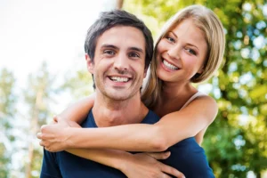 adult chiropractic care - smiling woman hugging her partner