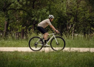 cyclist, riding a bike down a nature road - chiropractic care for athletes