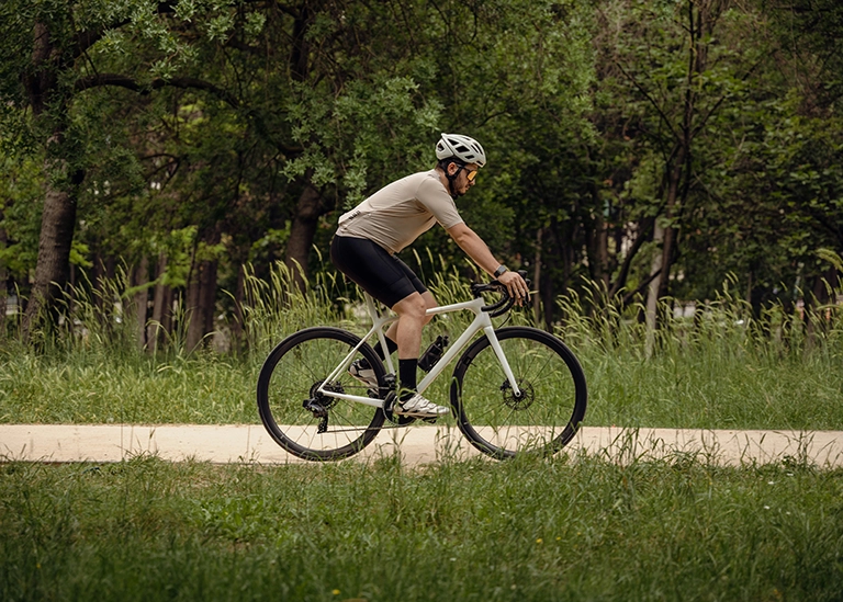 cyclist, riding a bike down a nature road - chiropractic care for athletes
