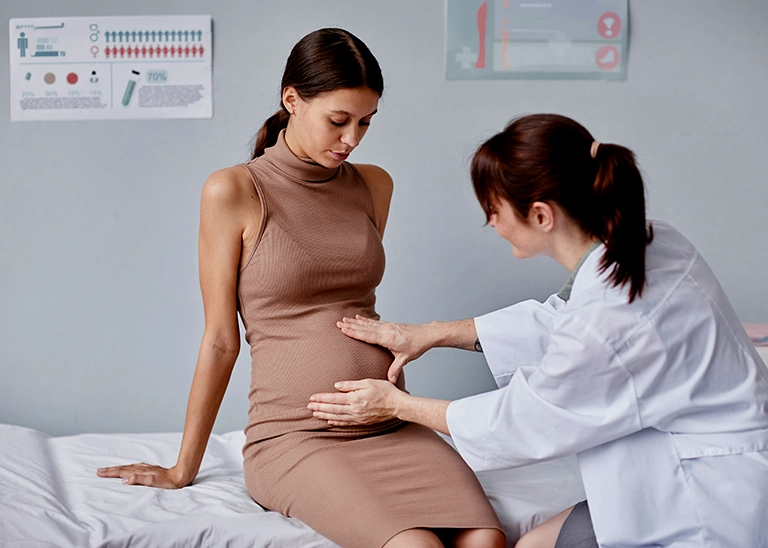 woman at her pregnancy check-up appointment with her doctor - chiropractic care for pregnancy in the second trimester