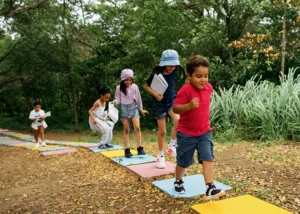 school-age children playing outside in a playground- pediatric chiropractic care