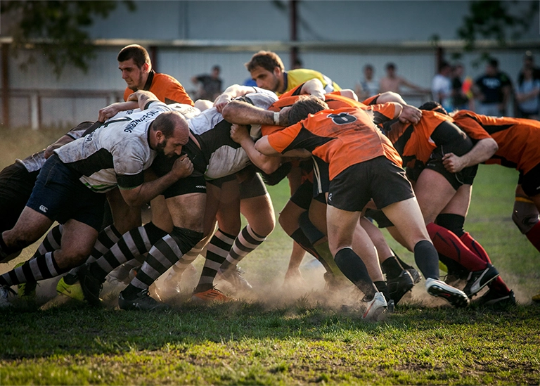 athletic team contact sport - rugby players tackling - chiropractic care for athletes