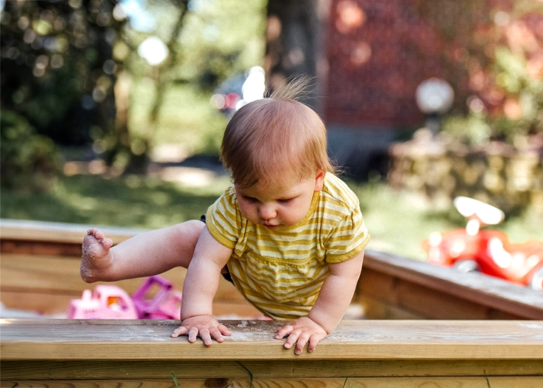baby playing in the backyard- pediatric chiropractic care