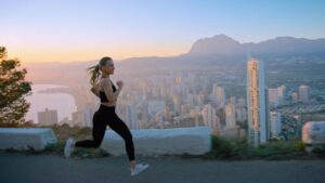 athletic woman running down a road - chiropractic care for athletes