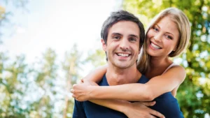 adult chiropractic care - smiling woman hugging her partner