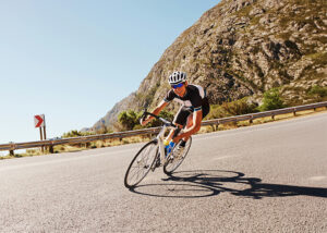 chiropractic care for athletes - cyclist riding bike down a long road